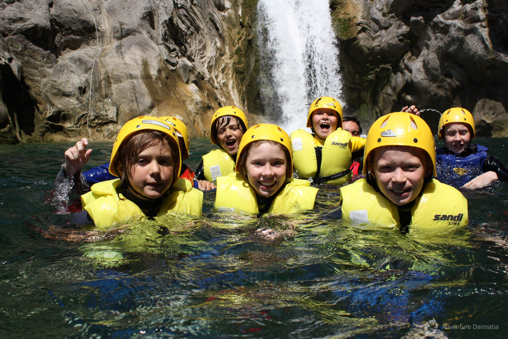 Under Great Gubavica waterfall in Cetina gorge, break on a canyoning tour